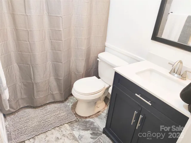 a white toilet sitting next to a bathroom sink