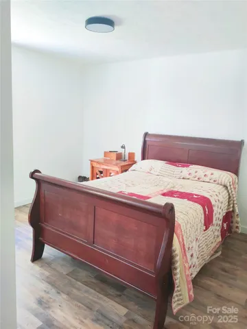 a bedroom with a bed and a mirror