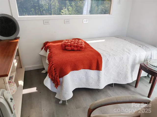 a bedroom with a bed and a mirror