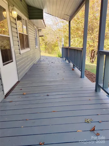 a view of a porch with wooden floor and furniture