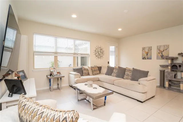 a living room with furniture and kitchen view