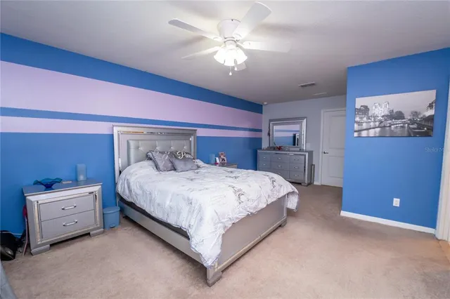a bathroom with a granite countertop sink a toilet and a mirror
