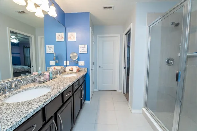 a bedroom with bed and a chandelier