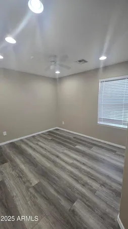 a view of room with window and wooden floor
