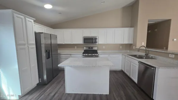 a kitchen with stainless steel appliances a sink stove and refrigerator