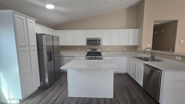 a kitchen with stainless steel appliances a sink stove and refrigerator