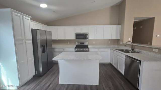 a kitchen with stainless steel appliances a sink stove and refrigerator