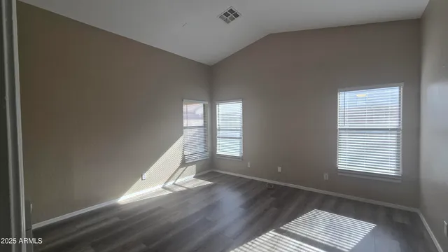 a view of wooden floor and windows in a room