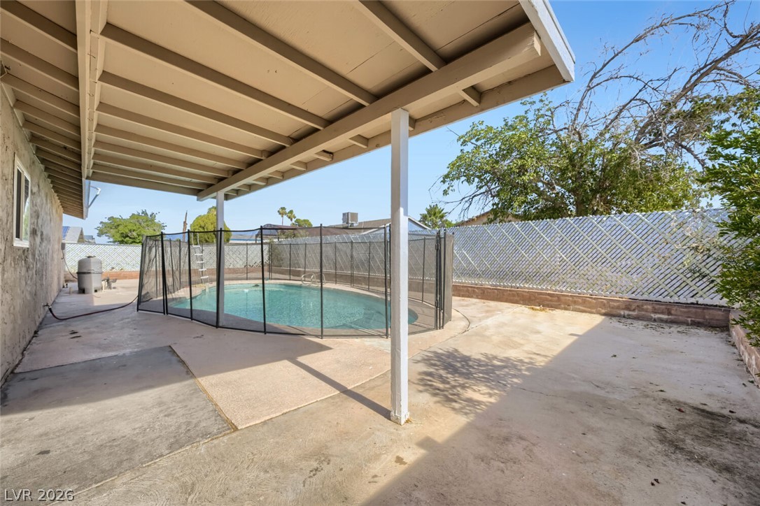 6321 Portola Road Las Vegas, NV 89108 - Photo 24 of 29 A private, fenced swimming pool and spacious patio create a tranquil backyard retreat.
