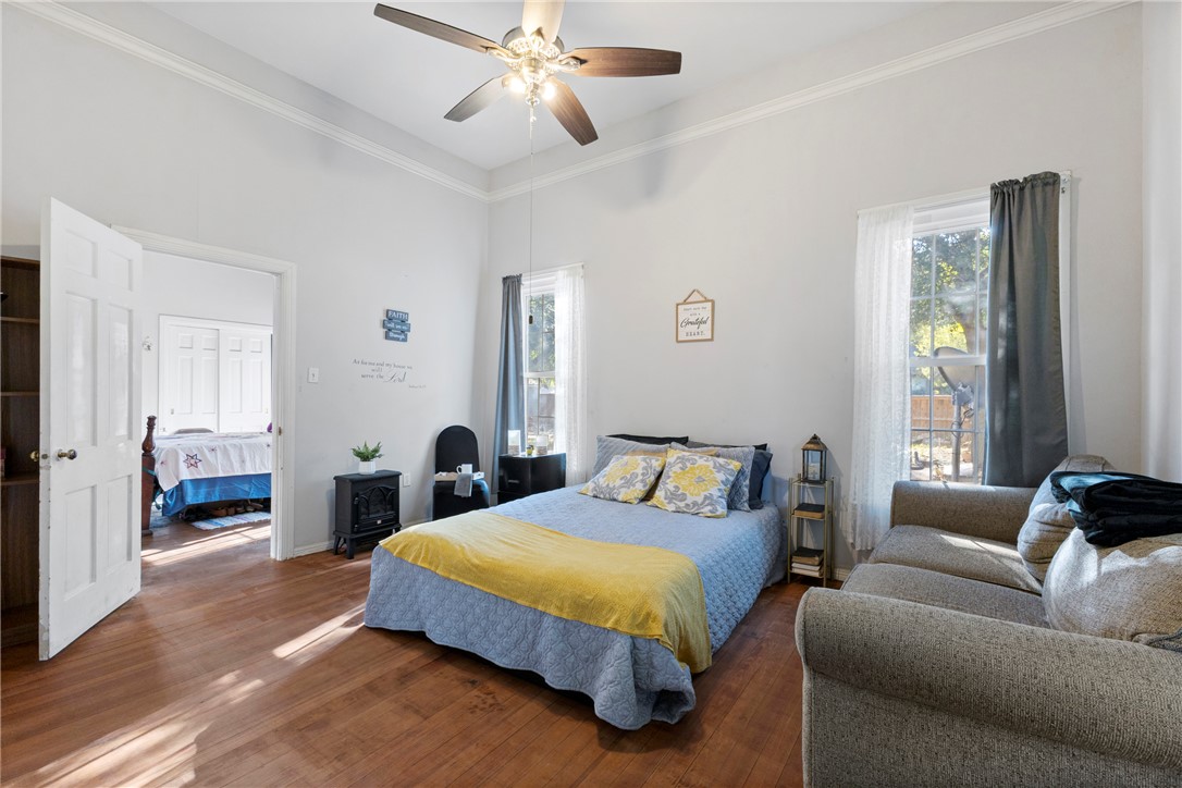 1007 South Magnolia Street Hearne, TX 77859 - Photo 11 of 25 a spacious bedroom with a bed a couch and a window