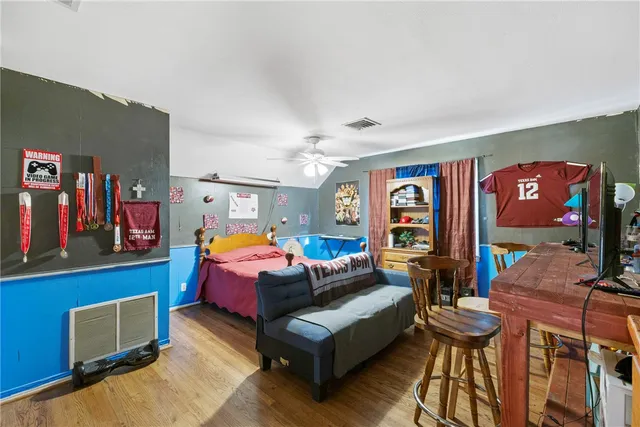 a bedroom with bed and a chandelier