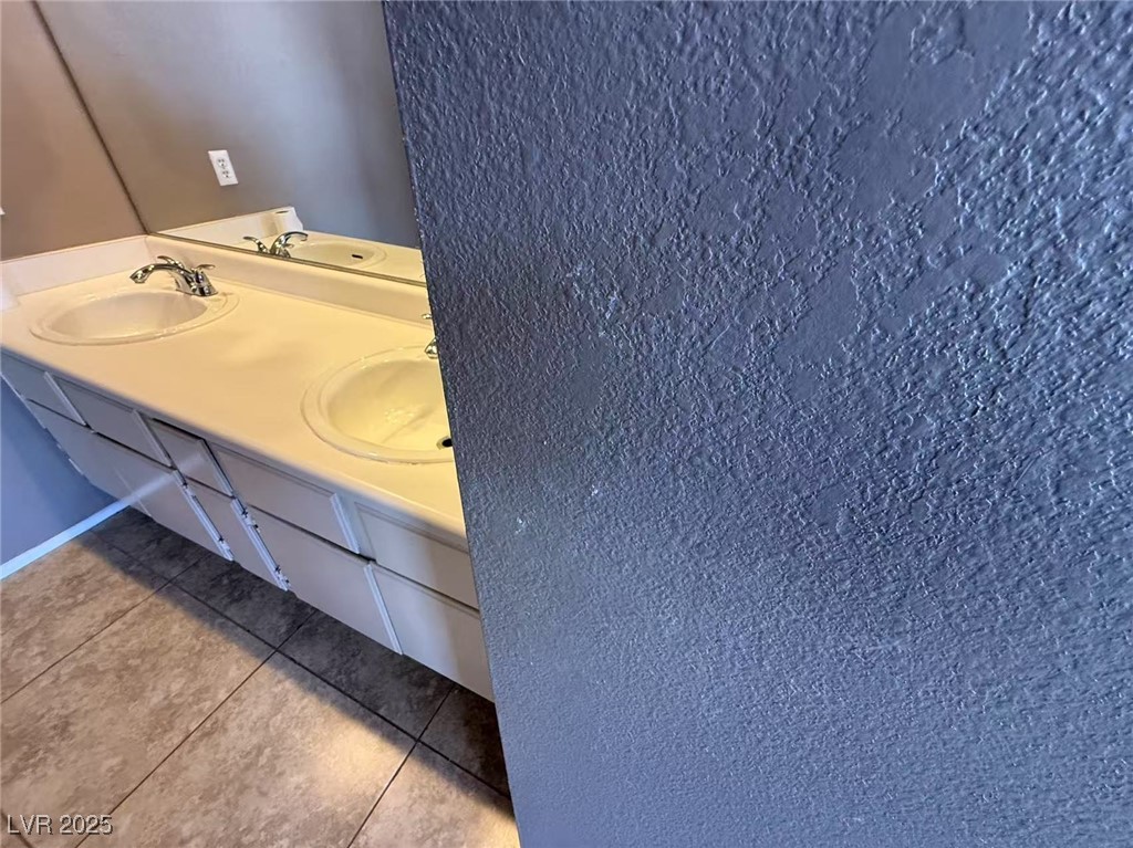 Undisclosed Address Las Vegas, NV 89142 - Photo 11 of 14 Bathroom with double vanity, a sink, and tile patt