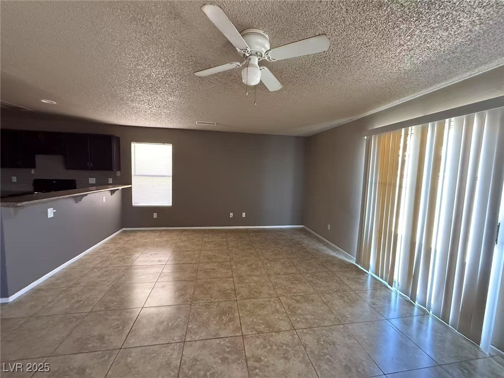 Undisclosed Address Las Vegas, NV 89142 - Photo 3 of 14 Unfurnished living room featuring baseboards, a ce