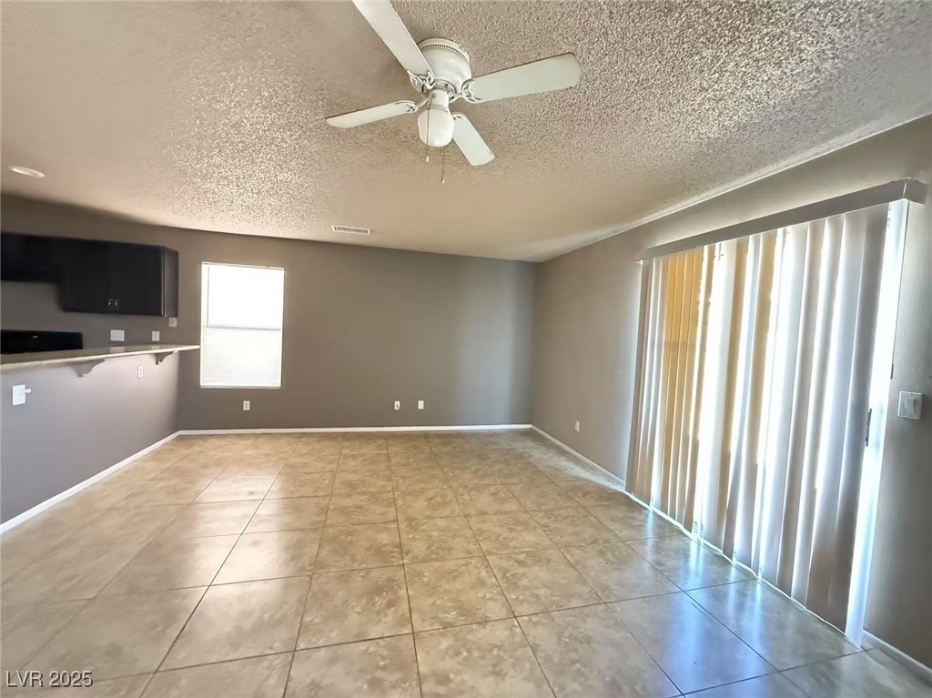 Undisclosed Address Las Vegas, NV 89142 - Photo 4 of 14 Unfurnished living room with visible vents, a text