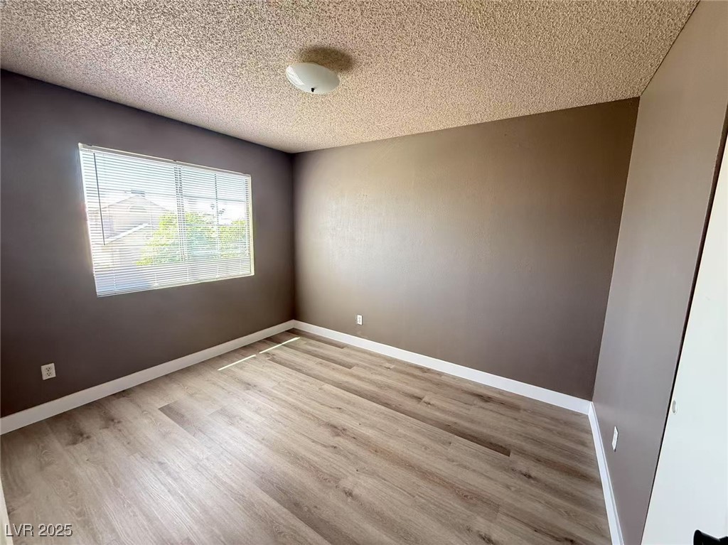 Undisclosed Address Las Vegas, NV 89142 - Photo 8 of 14 Spare room featuring baseboards, a textured ceilin