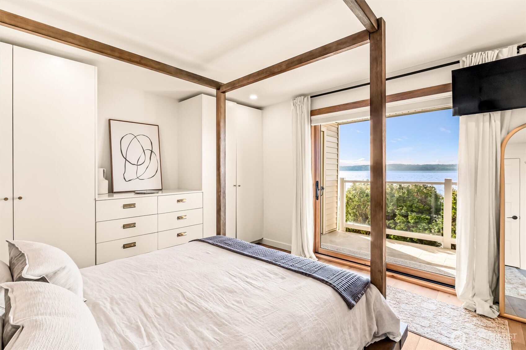 10203 47th Avenue Southwest, Unit D2 Seattle, WA 98146 - Photo 11 of 36 a bedroom with a bed and a flat tv screen on the dresser