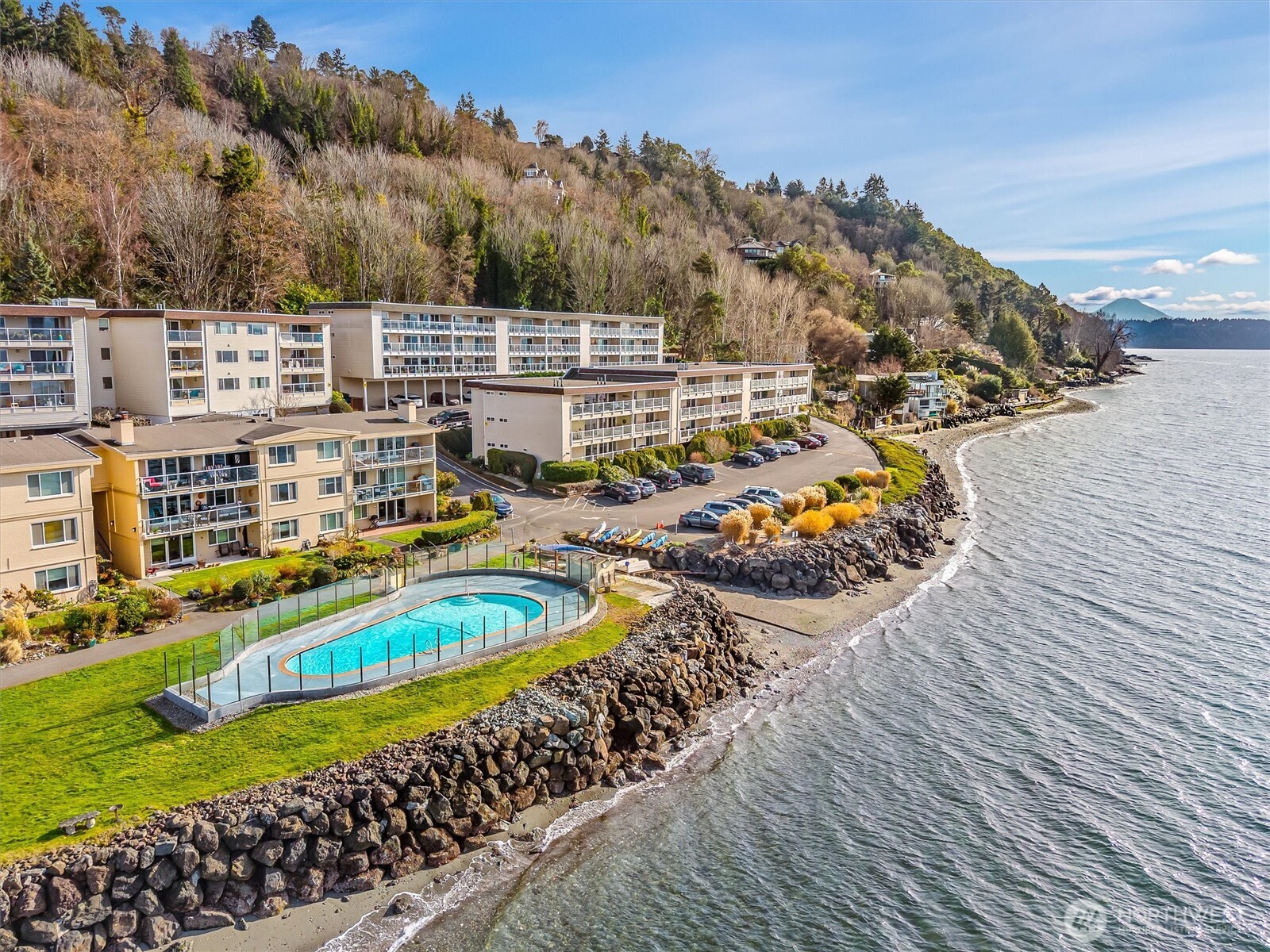 10203 47th Avenue Southwest, Unit D2 Seattle, WA 98146 - Photo 2 of 36 a view of a swimming pool with outdoor seating and plants