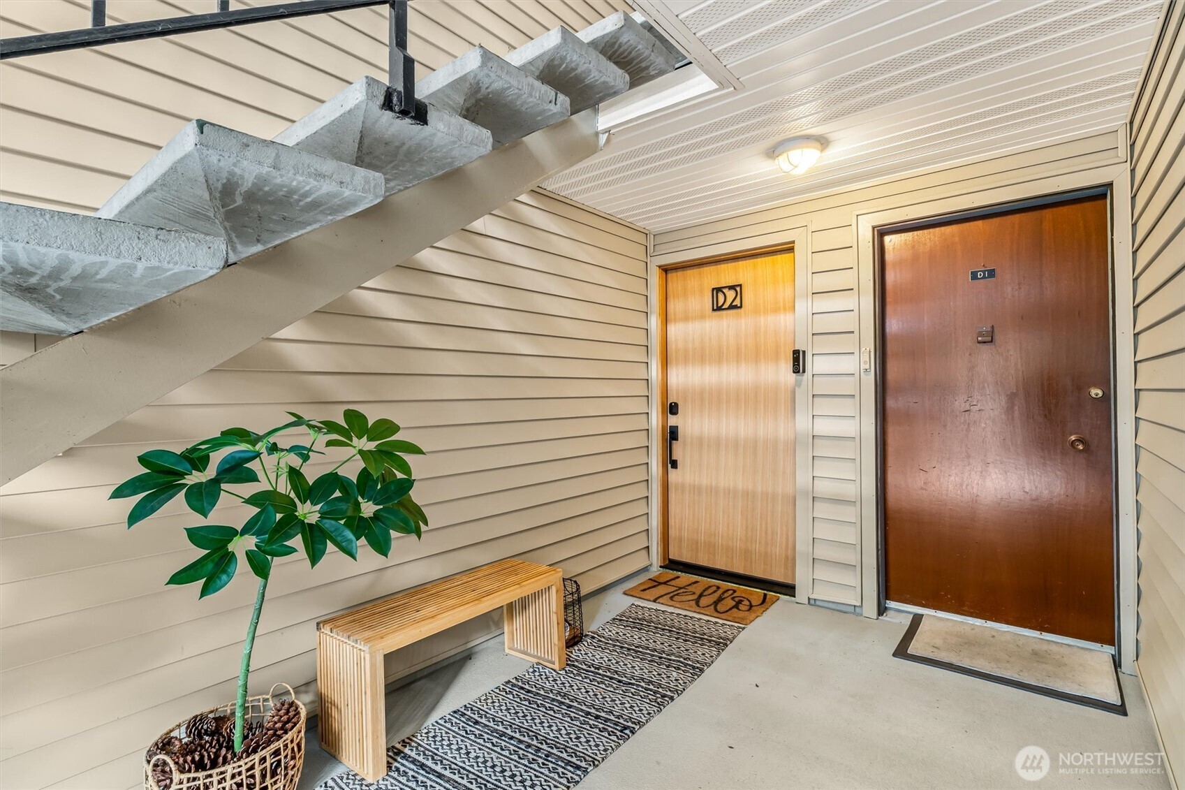 10203 47th Avenue Southwest, Unit D2 Seattle, WA 98146 - Photo 31 of 36 a potted plant sitting in front of a door