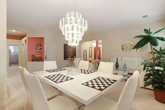 a living room with furniture potted plant and a wooden floor