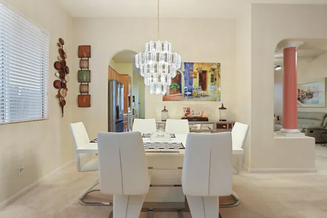 a living room with furniture a fireplace and a potted plant