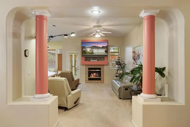 a kitchen with stainless steel appliances kitchen island granite countertop a sink a stove a oven a dining table and chairs