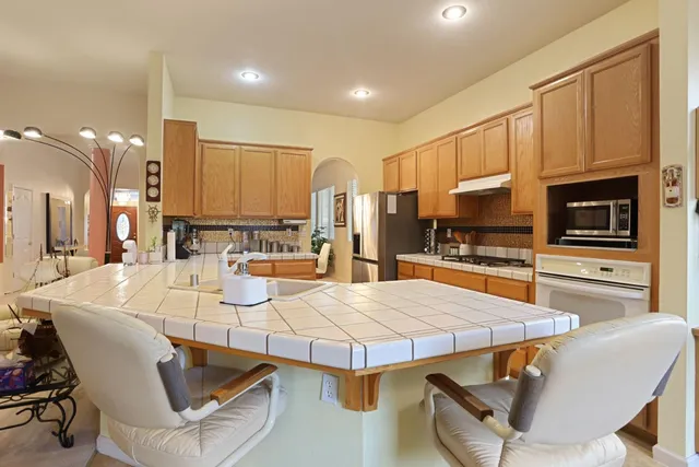a kitchen with stainless steel appliances a refrigerator sink and cabinets