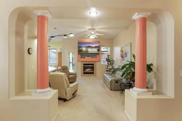 a view of a workspace with furniture and a window