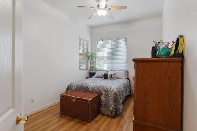 a bedroom with a bed and a flat tv screen on the dresser