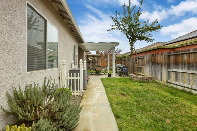 a view of a chairs and table in backyard of the house