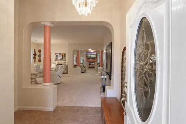 a view of a bedroom with furniture and chandelier