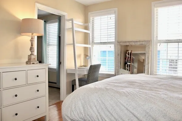 a bedroom with a bed and a window