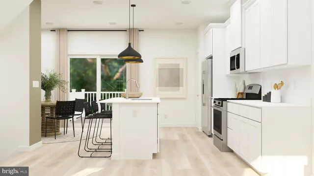 a kitchen with a sink a counter top space and stainless steel appliances