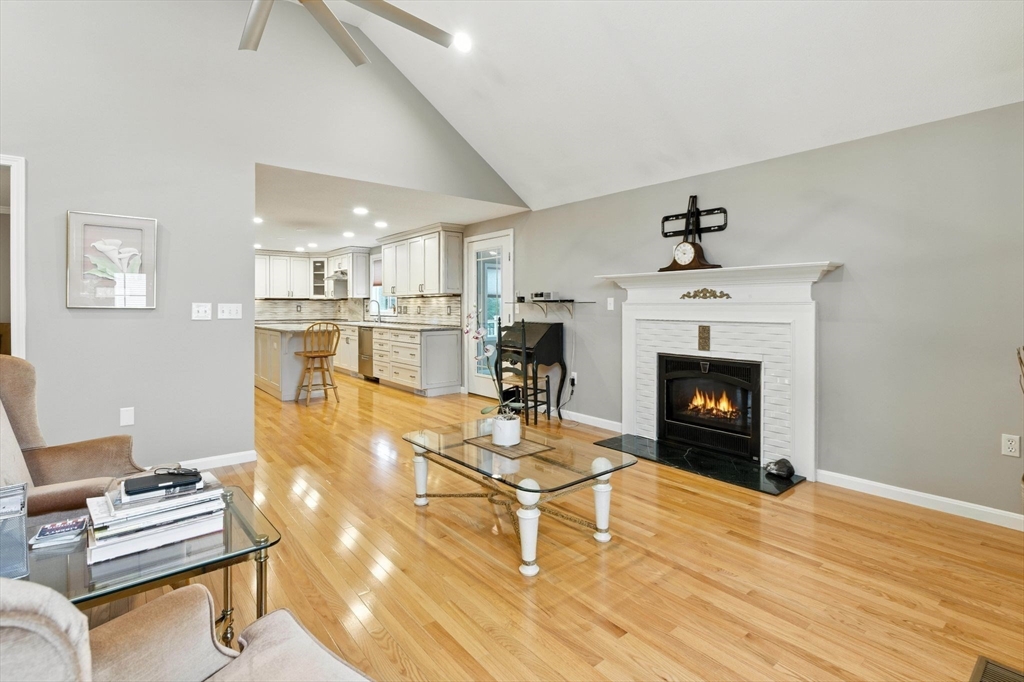 13 Colonial Drive Clinton, MA 01510 - Photo 12 of 42 a living room with furniture a fireplace and a table