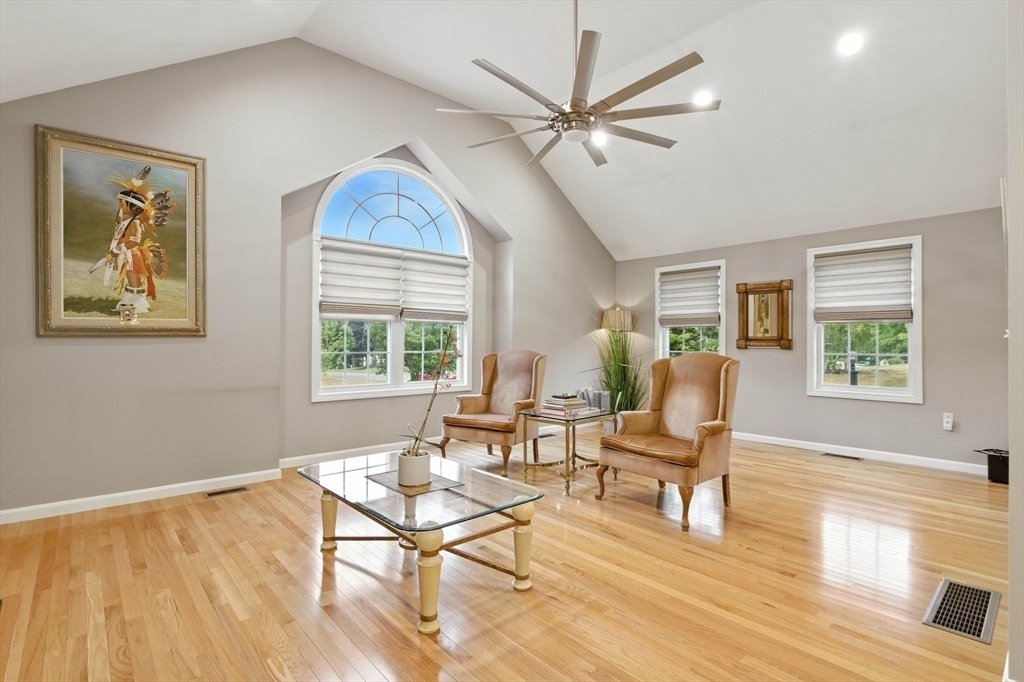 13 Colonial Drive Clinton, MA 01510 - Photo 13 of 42 a living room with furniture a window and a chandelier