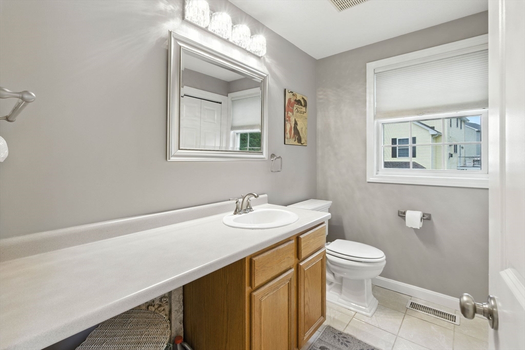 13 Colonial Drive Clinton, MA 01510 - Photo 22 of 42 a bathroom with a sink a toilet and mirror