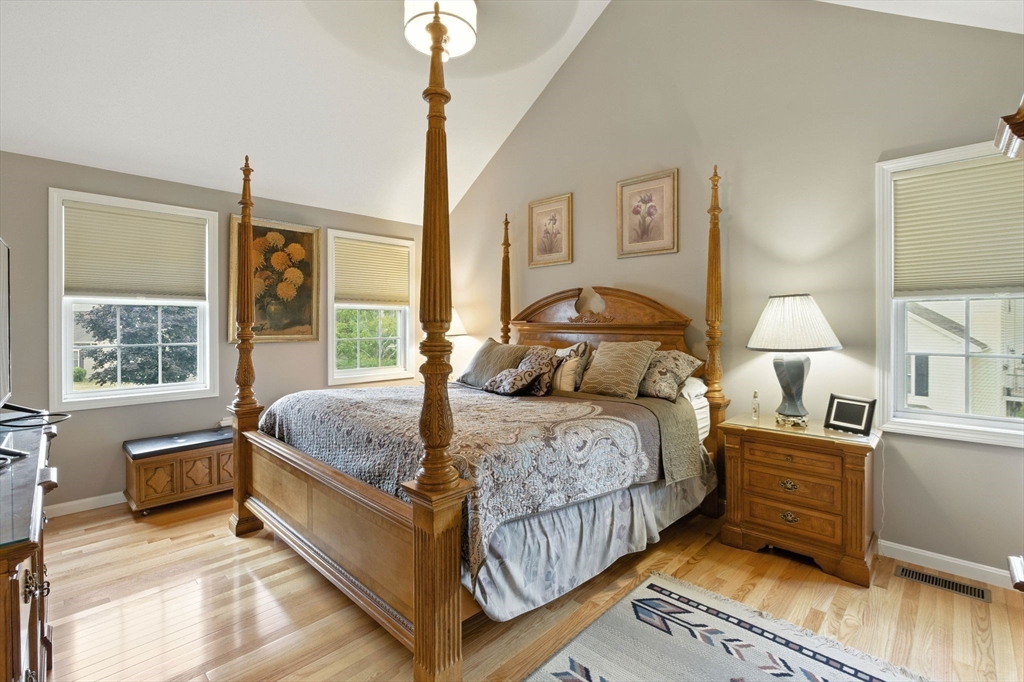 13 Colonial Drive Clinton, MA 01510 - Photo 24 of 42 a bedroom with a large bed and a chandelier