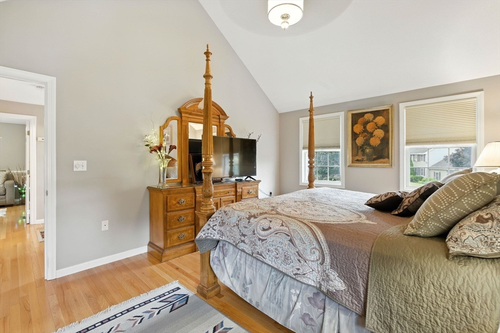 13 Colonial Drive Clinton, MA 01510 - Photo 25 of 42 a bedroom with a bed a mirror on dresser and a large window