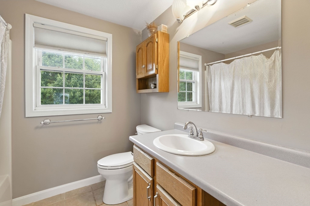13 Colonial Drive Clinton, MA 01510 - Photo 26 of 42 a bathroom with a sink a toilet and a mirror