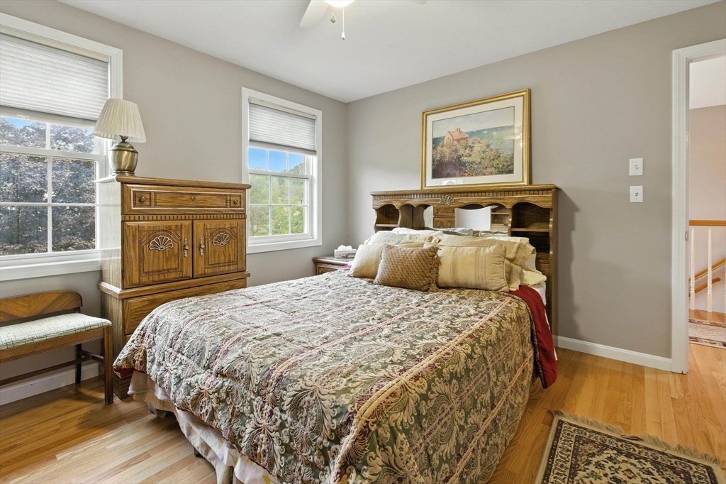 13 Colonial Drive Clinton, MA 01510 - Photo 27 of 42 a bedroom with a bed and a dresser next to a window