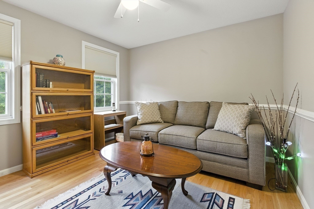 13 Colonial Drive Clinton, MA 01510 - Photo 28 of 42 a living room with furniture and a wooden floor