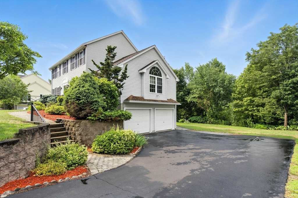 13 Colonial Drive Clinton, MA 01510 - Photo 3 of 42 a front view of a house with a yard and potted plants
