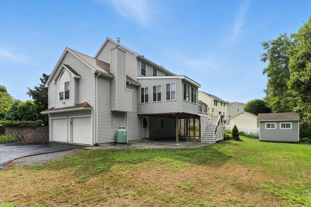 13 Colonial Drive Clinton, MA 01510 - Photo 36 of 42 a view of a white house with a big yard and large trees
