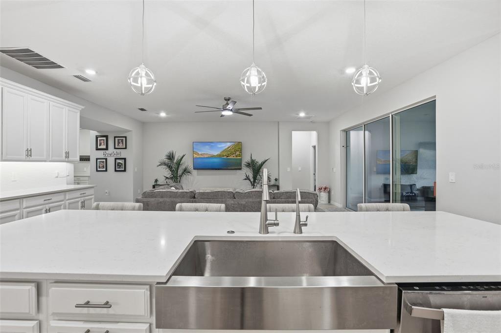 1271 Waterview Ridge Circle Apopka, FL 32703 - Photo 14 of 56 a kitchen with kitchen island a sink and a stove with wooden floor