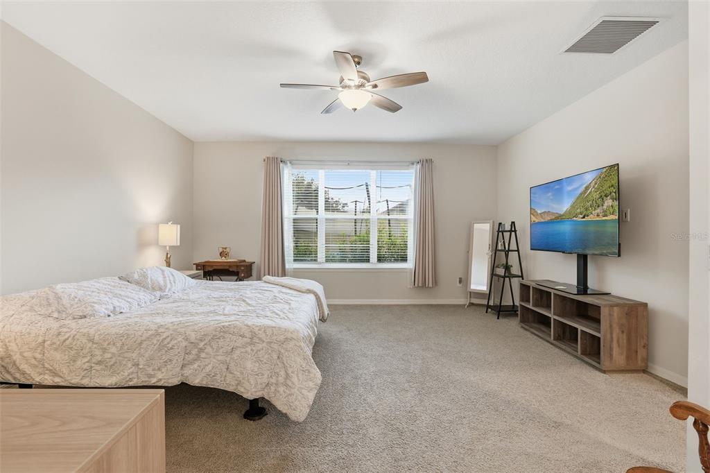 1271 Waterview Ridge Circle Apopka, FL 32703 - Photo 18 of 56 a bedroom with a bed and a flat screen tv