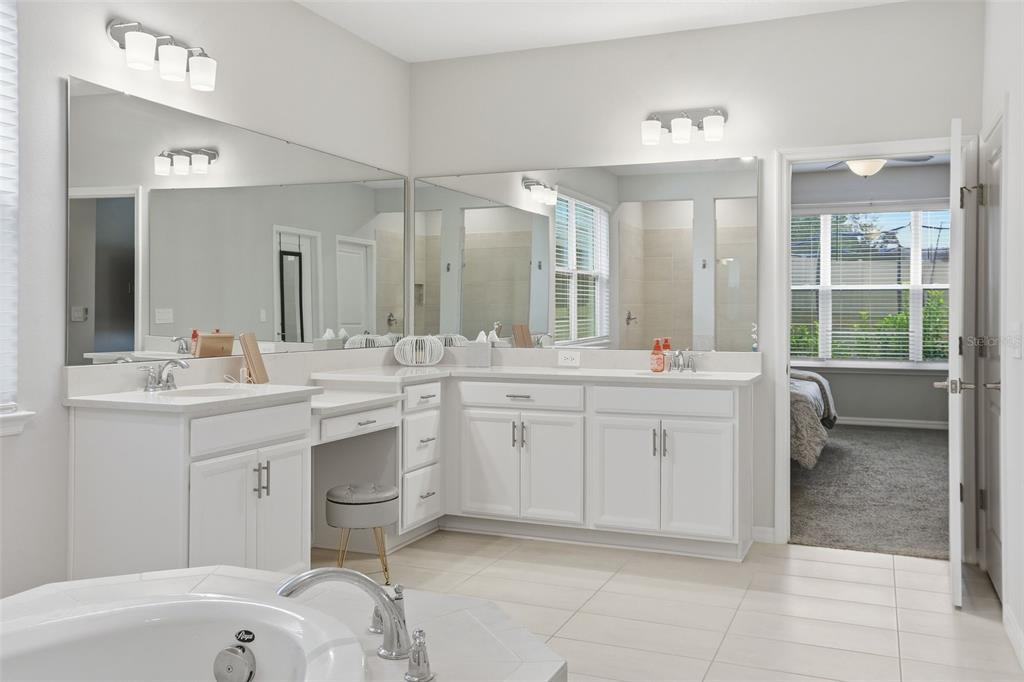 1271 Waterview Ridge Circle Apopka, FL 32703 - Photo 22 of 56 a spacious bathroom with a double vanity sink a mirror and a bathtub
