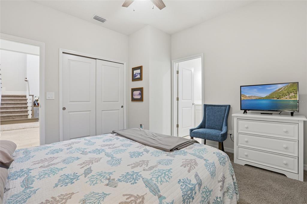 1271 Waterview Ridge Circle Apopka, FL 32703 - Photo 27 of 56 a bedroom with a bed and a flat screen tv