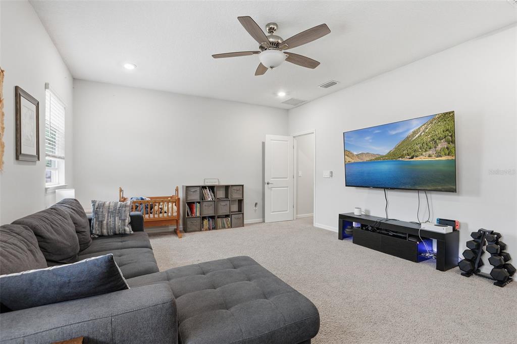 1271 Waterview Ridge Circle Apopka, FL 32703 - Photo 32 of 56 a living room with furniture and a flat screen tv