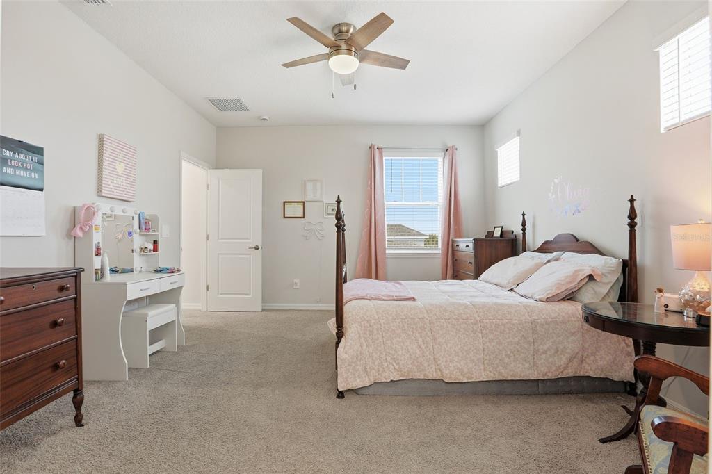 1271 Waterview Ridge Circle Apopka, FL 32703 - Photo 34 of 56 a bedroom with a bed and a chandelier