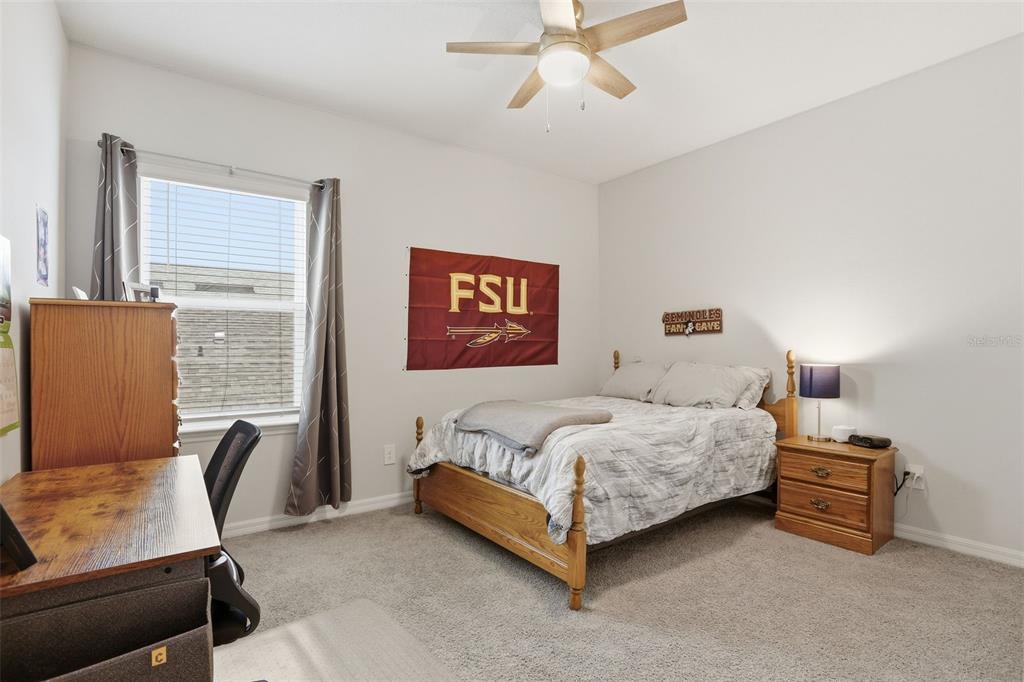 1271 Waterview Ridge Circle Apopka, FL 32703 - Photo 39 of 56 a bedroom with a bed chair and a window