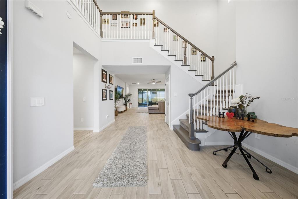 1271 Waterview Ridge Circle Apopka, FL 32703 - Photo 4 of 56 a view of a hallway with wooden floor and stairs
